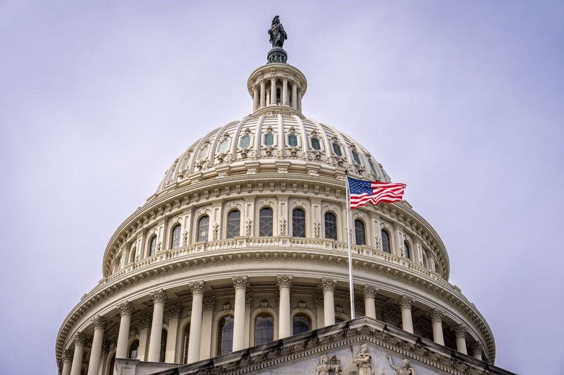 The dome of the United States Capitol with an American flag