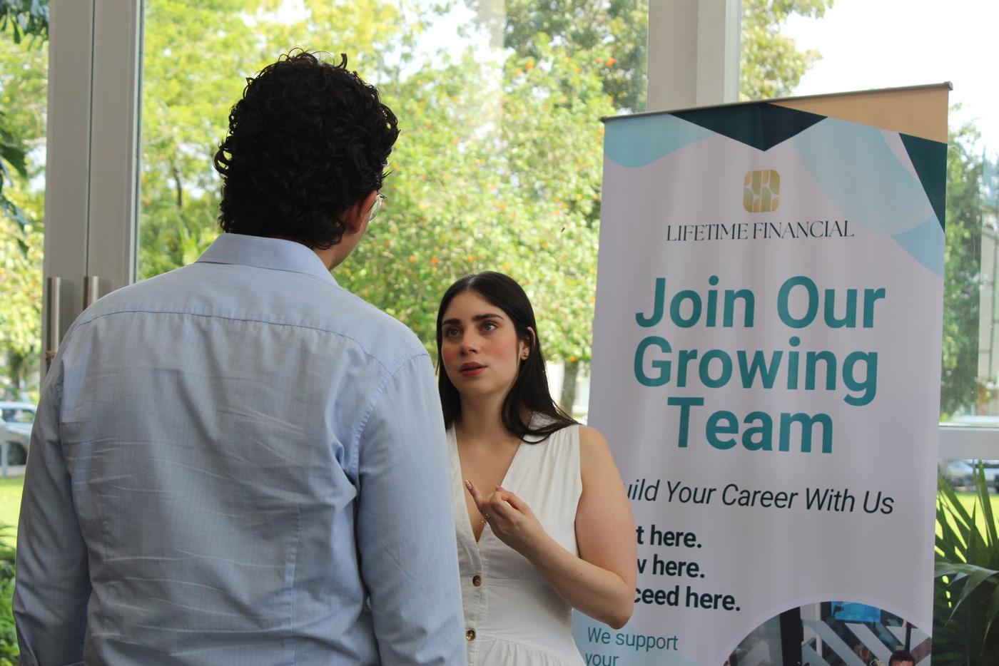 A Lifetime Financial team member speaking with a candidate at a career fair