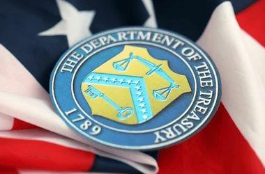The seal of the Department of the Treasury on an American flag
